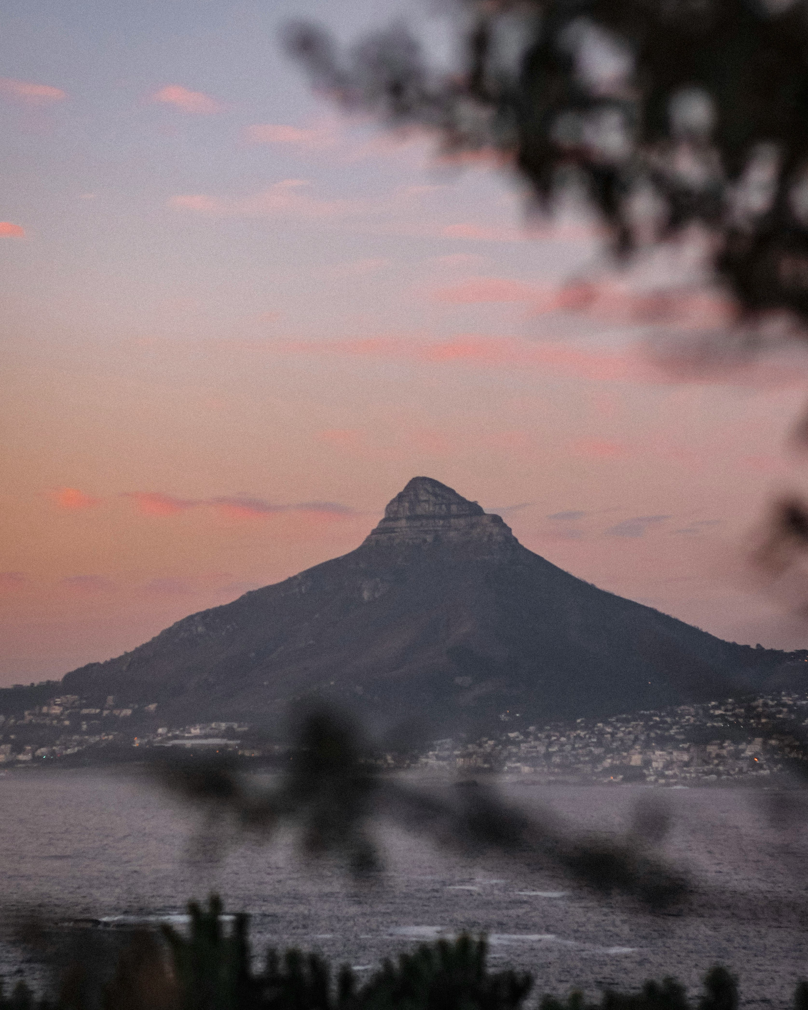 mountain near body of water during sunset